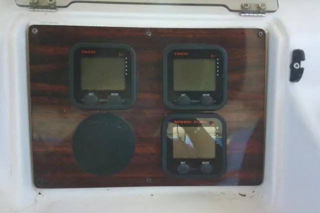 Slide: The Image of Control panel of a 2000 Grady-White Sailfish 272 boat with tachometers and speed gauge. - 30
