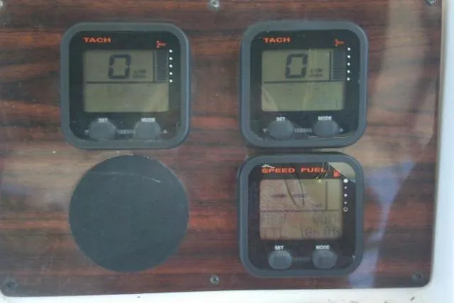 Slide: The Image of Dashboard of a 2000 Grady-White Sailfish 272 boat with tachometer and fuel gauges. - 35