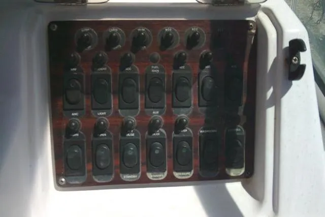 Slide: The Image of Control panel of a 2000 Grady-White Sailfish 272 boat with labeled switches. - 36