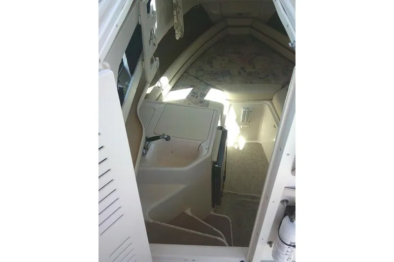 Slide: The Image of Interior cabin of 2000 Grady-White Sailfish 272 boat, featuring compact amenities and seating. - 38
