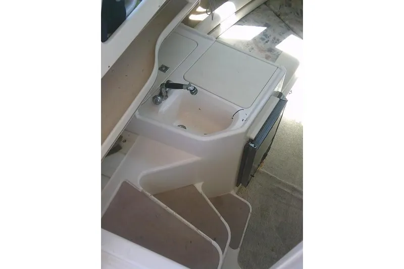 Slide: The Image of Interior view of 2000 Grady-White Sailfish 272 boat, featuring a compact sink and storage area. - 39