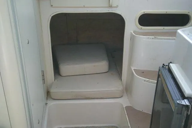 Slide: The Image of Interior cabin of 2000 Grady-White Sailfish 272 boat with cushions and compact design. - 41