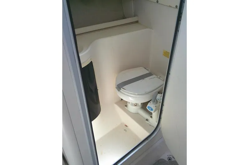 Slide: The Image of 2000 Grady-White Sailfish 272 boat bathroom interior with compact toilet setup. - 43