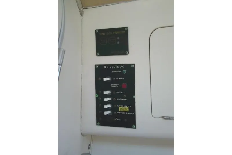 Slide: The Image of Electrical panel on a 2000 Grady-White Sailfish 272 boat, featuring AC controls and indicators. - 45