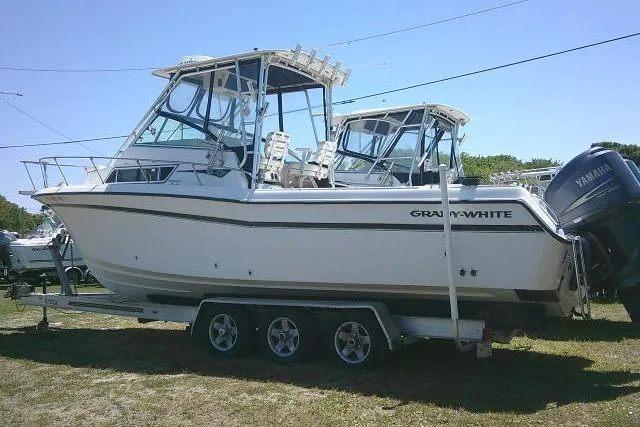 Slide: The Image of 2000 Grady-White Sailfish 272 boat on trailer, featuring Yamaha outboard engines. - 5