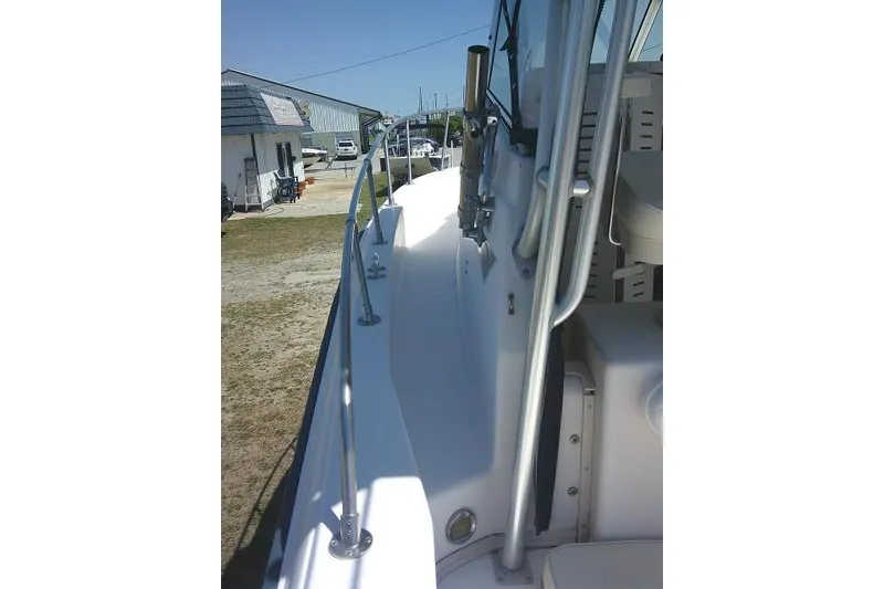 Slide: The Image of 2000 Grady-White Sailfish 272 boat deck with railing, docked near buildings. - 51