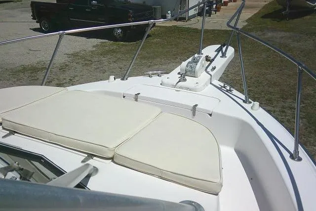 Slide: The Image of 2000 Grady-White Sailfish 272 boat deck with cushioned seating and railing. - 53