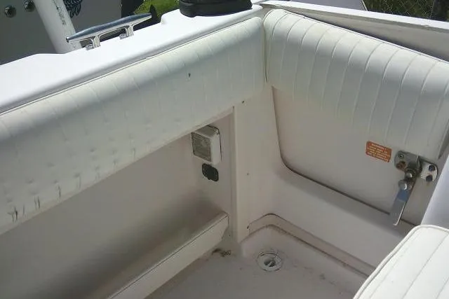 Slide: The Image of Interior view of a 2000 Grady-White Sailfish 272 boat, featuring white cushioned seating. - 56