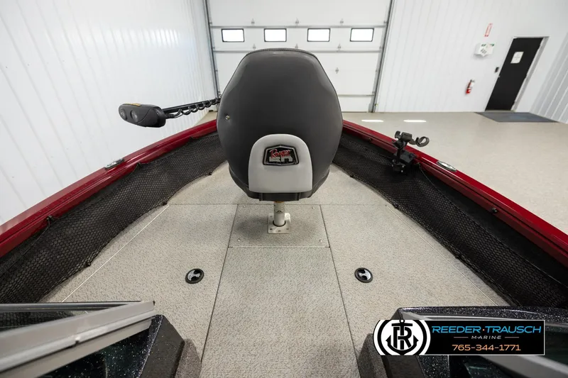 Slide: The Image of 2018 Ranger VS1882 WT boat interior with seat and trolling motor in a garage. - 14