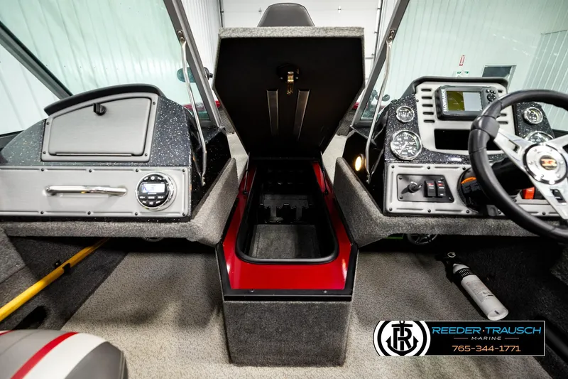 Slide: The Image of 2018 Ranger VS1882 WT boat interior with open storage, dashboard, and steering wheel. - 24