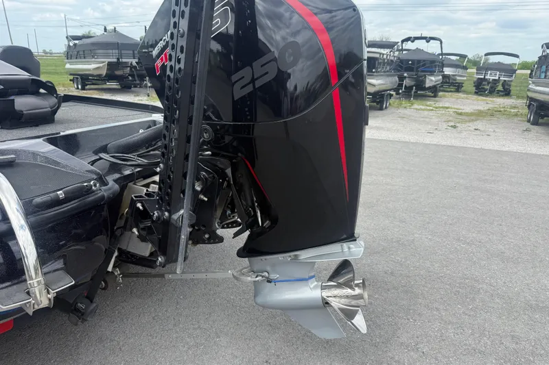 Slide: The Image of 2019 Nitro Z21 Pro boat with powerful outboard motor, parked on a paved surface. - 13