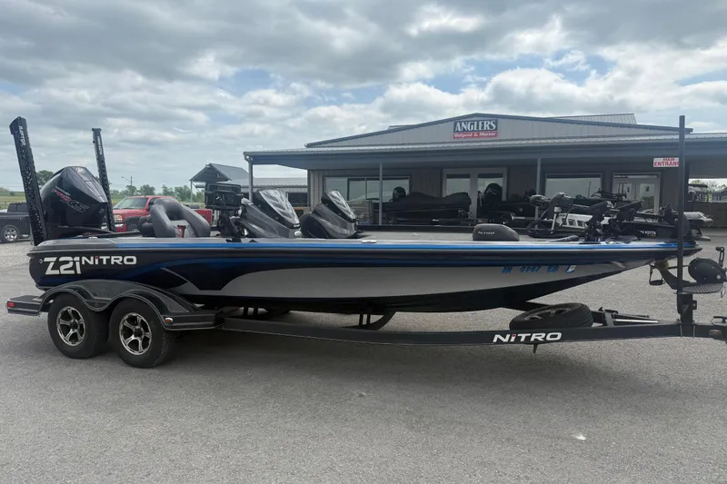 Slide: The Image of 2019 Nitro Z21 Pro boat parked outside Anglers store under cloudy sky. - 3