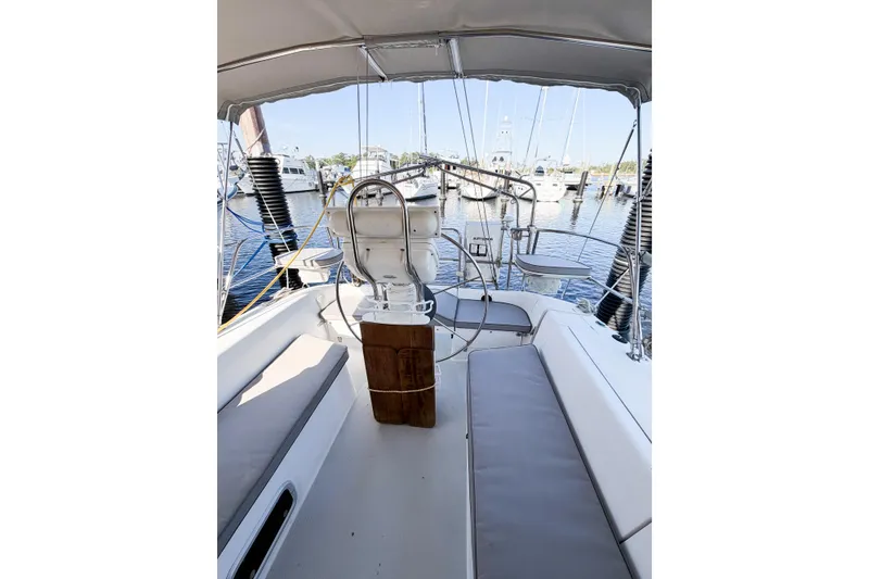 Slide: The Image of 1996 Catalina 36 MkII sailboat cockpit with seating, steering wheel, and marina view. - 13