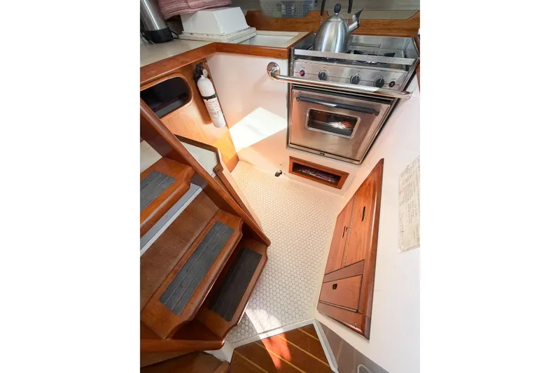 Slide: The Image of Compact galley kitchen in 1996 Catalina 36 MkII sailboat with stove and wooden cabinetry. - 23