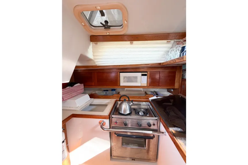 Slide: The Image of Cozy galley kitchen in 1996 Catalina 36 MkII sailboat with stove, microwave, and storage. - 24