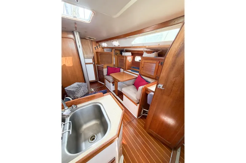 Slide: The Image of Interior of a 1996 Catalina 36 MkII sailboat with wooden cabinetry and seating area. - 25