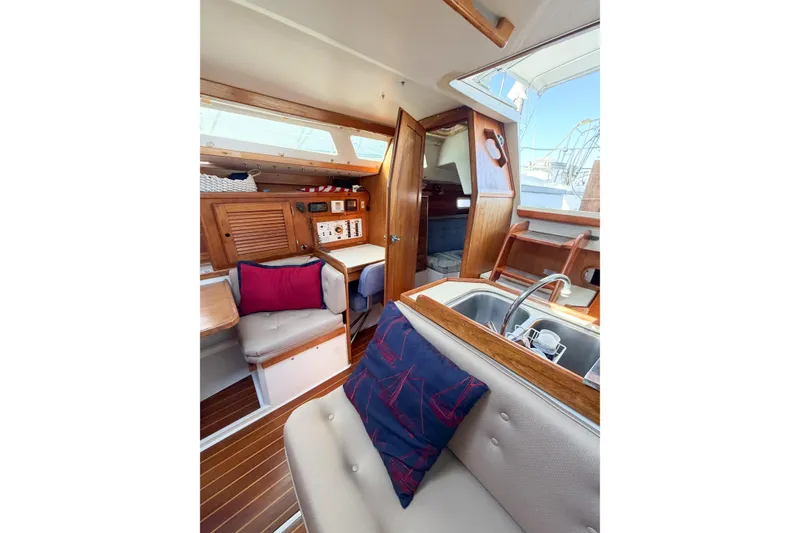 Slide: The Image of Interior of a 1996 Catalina 36 MkII sailboat with cozy seating and wooden accents. - 26