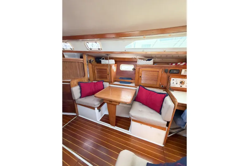 Slide: The Image of Interior of 1996 Catalina 36 MkII sailboat with wooden furnishings and cozy seating area. - 28