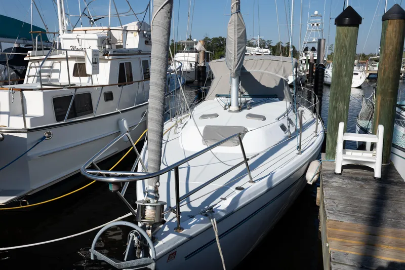 Slide: The Image of 1996 Catalina 36 MkII sailboat docked at marina, surrounded by other boats. - 3