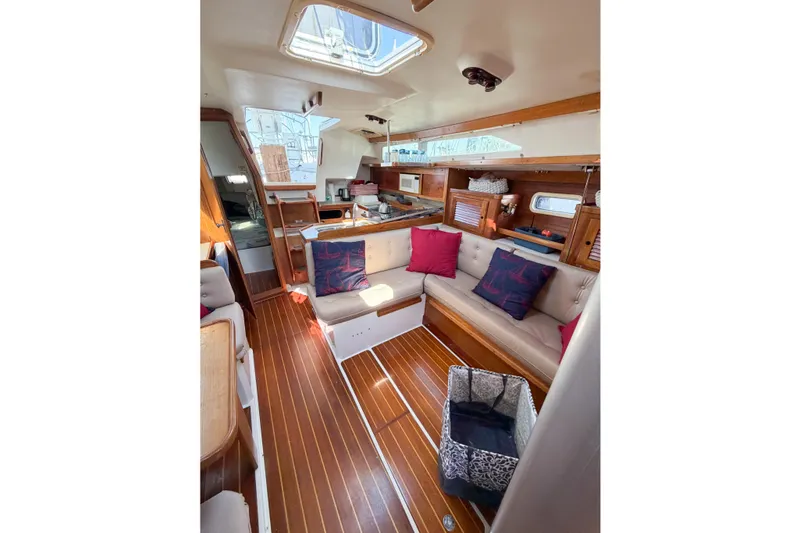 Slide: The Image of Interior of a 1996 Catalina 36 MkII sailboat with cozy seating and wooden flooring. - 33