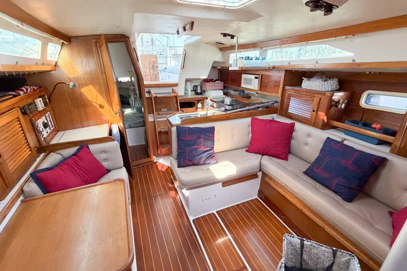 Slide: The Image of Interior of a 1996 Catalina 36 MkII sailboat with cozy seating and wooden finishes. - 34