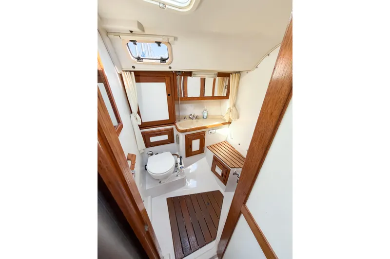 Slide: The Image of Interior of 1996 Catalina 36 MkII yacht bathroom with wooden accents and compact design. - 36