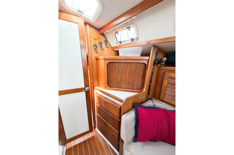 Slide: The Image of Interior of 1996 Catalina 36 MkII sailboat with wooden cabinetry and colorful cushions. - 38