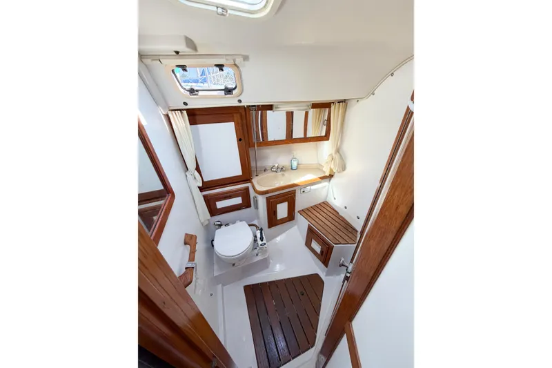 Slide: The Image of Interior of 1996 Catalina 36 MkII yacht bathroom with wooden accents and compact design. - 41