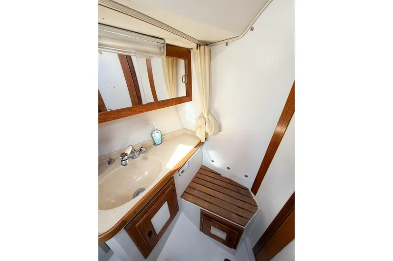 Slide: The Image of Bathroom interior of 1996 Catalina 36 MkII sailboat with sink and wooden accents. - 43