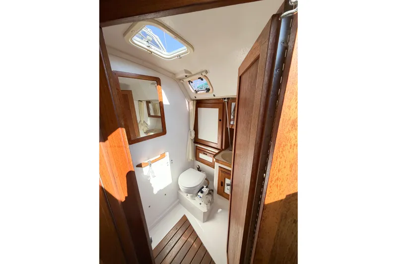 Slide: The Image of Interior of 1996 Catalina 36 MkII sailboat bathroom with wooden accents and skylight. - 53