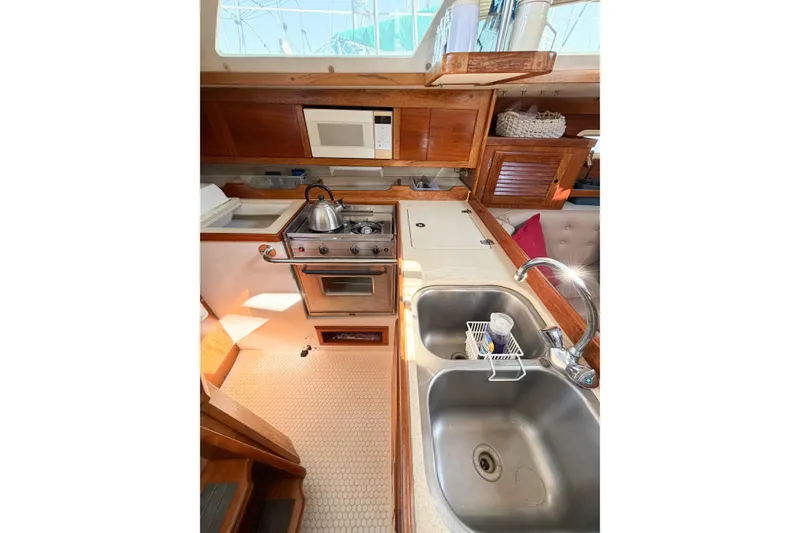 Slide: The Image of Interior of 1996 Catalina 36 MkII yacht kitchen with stove, sink, and microwave. - 55