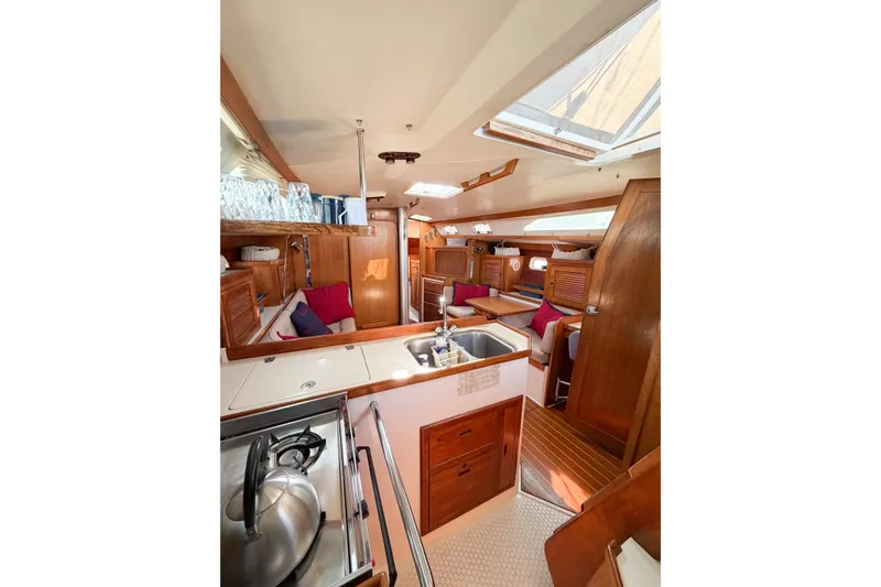 Slide: The Image of Interior of 1996 Catalina 36 MkII sailboat with cozy seating and wooden cabinetry. - 57