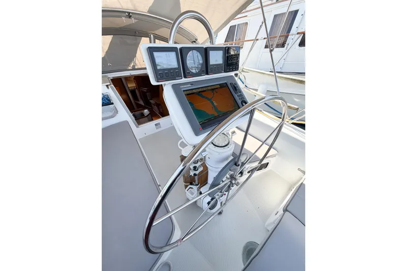 Slide: The Image of Cockpit of 1996 Catalina 36 MkII sailboat with navigation instruments and steering wheel. - 64