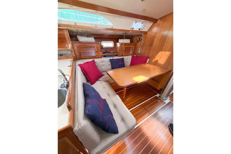 Slide: The Image of Interior of 1996 Catalina 36 MkII sailboat with cozy seating and wooden table. - 65