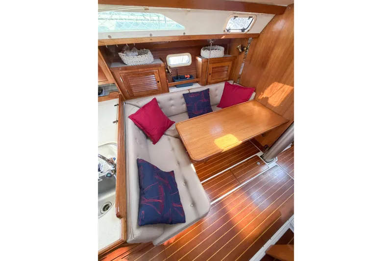 Slide: The Image of Interior of 1996 Catalina 36 MkII sailboat with cozy dining area and colorful cushions. - 66