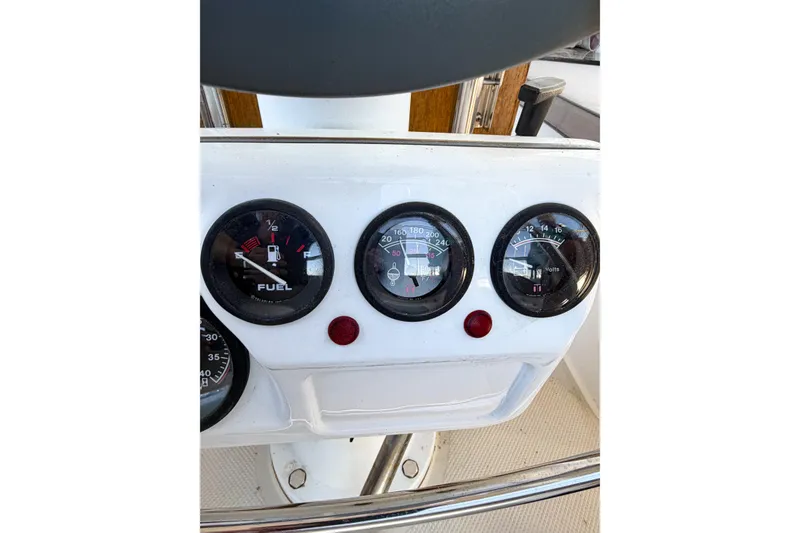 Slide: The Image of Instrument panel of a 1996 Catalina 36 MkII sailboat, displaying fuel, temperature, and voltage gauges. - 76