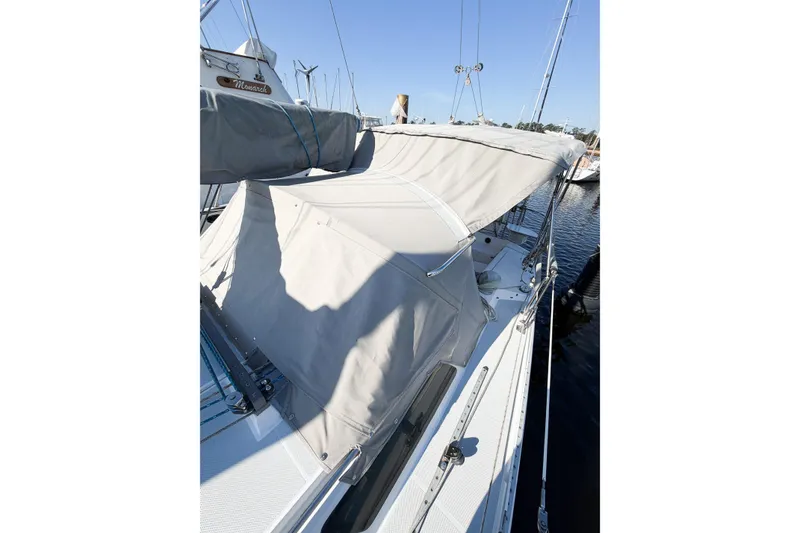Slide: The Image of 1996 Catalina 36 MkII sailboat with covered deck, docked at marina. - 8