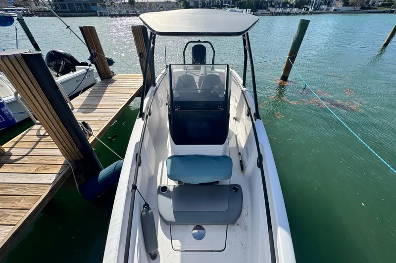 Slide: The Image of 2022 Axopar 22 T-Top boat docked on calm water, showcasing sleek design. - 11