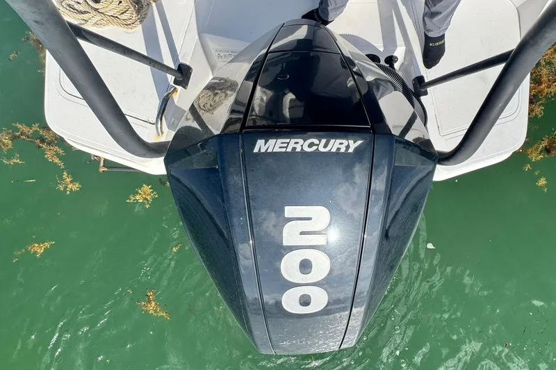 Slide: The Image of Mercury 200 outboard motor on 2022 Axopar 22 T-Top boat in green water. - 17