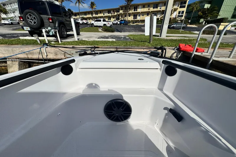 Slide: The Image of 2022 Axopar 22 T-Top boat interior at dockside, featuring modern design elements. - 9