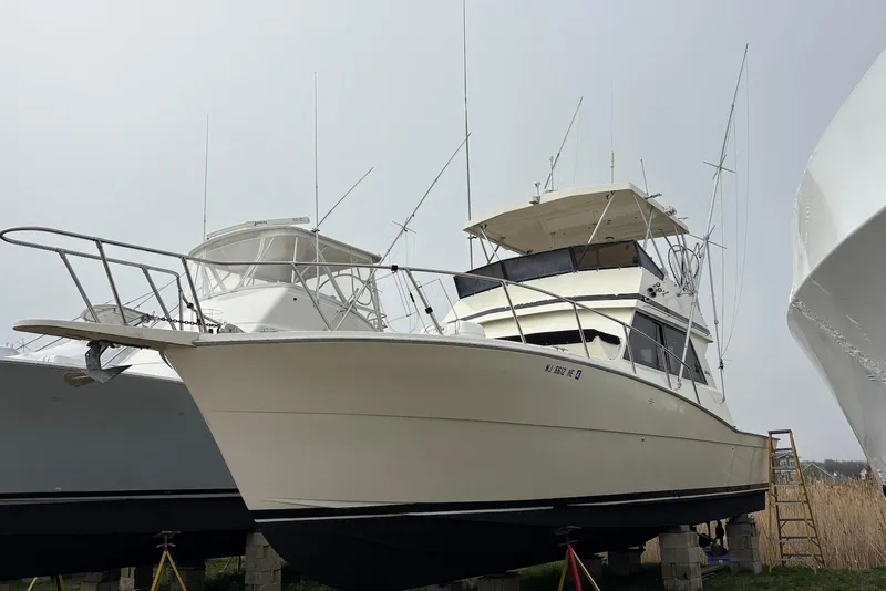 The Image of 1988 Viking 41 Convertible yacht docked at marina under clear blue sky. - 0