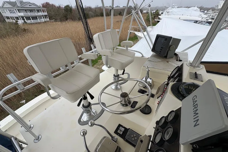 Slide: The Image of 1988 Viking 41 Convertible boat deck with stairs and storage compartments. - 10