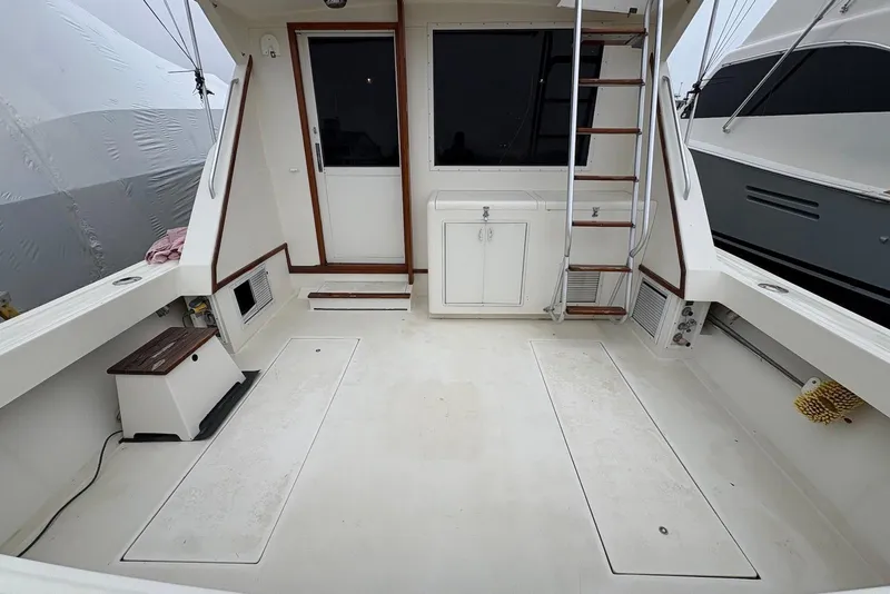 Slide: The Image of 1988 Viking 41 Convertible boat named "Hide Seek" on dry dock with ladder nearby. - 11