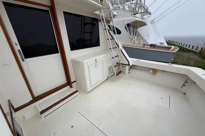 Slide: The Image of 1988 Viking 41 Convertible yacht helm with navigation equipment, overlooking marina with docked boats. - 13