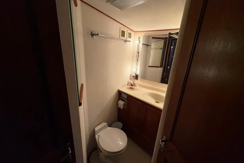 Slide: The Image of 1988 Viking 41 Convertible yacht with flybridge and fishing gear, docked in a marina. - 19