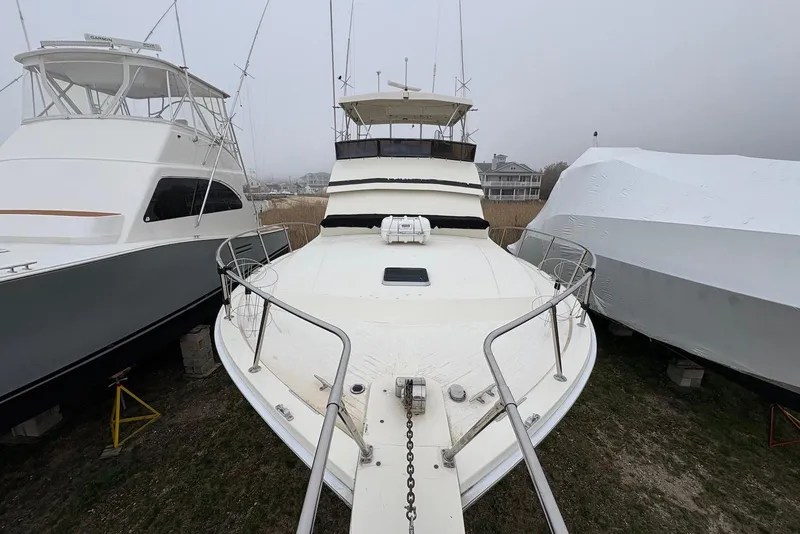 Slide: The Image of 1988 Viking 41 Convertible yacht docked at marina under clear blue sky. - 2