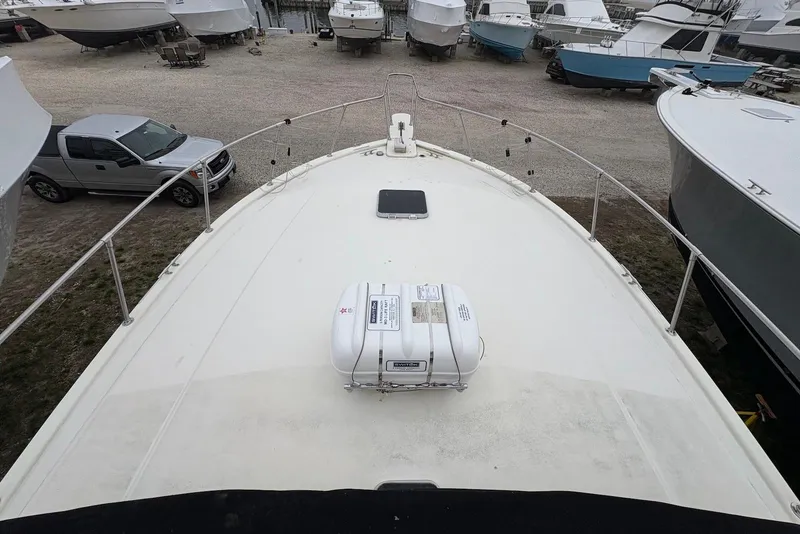 Slide: The Image of 1988 Viking 41 Convertible boat docked at marina under clear blue sky. - 3