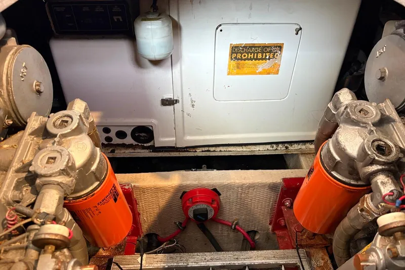 Slide: The Image of Engine room of a 1988 Viking 41 Convertible boat, featuring filters and mechanical components. - 31