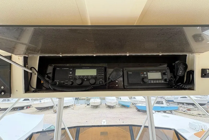 Slide: The Image of 1988 Viking 41 Convertible boat radio equipment with view of docked boats. - 32