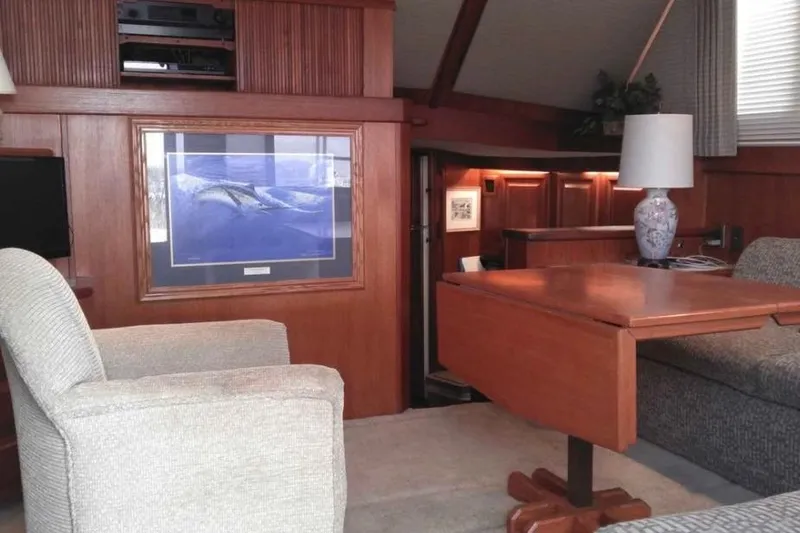 Slide: The Image of Interior of a 1988 Viking 41 Convertible yacht with cozy seating and wooden furnishings. - 36